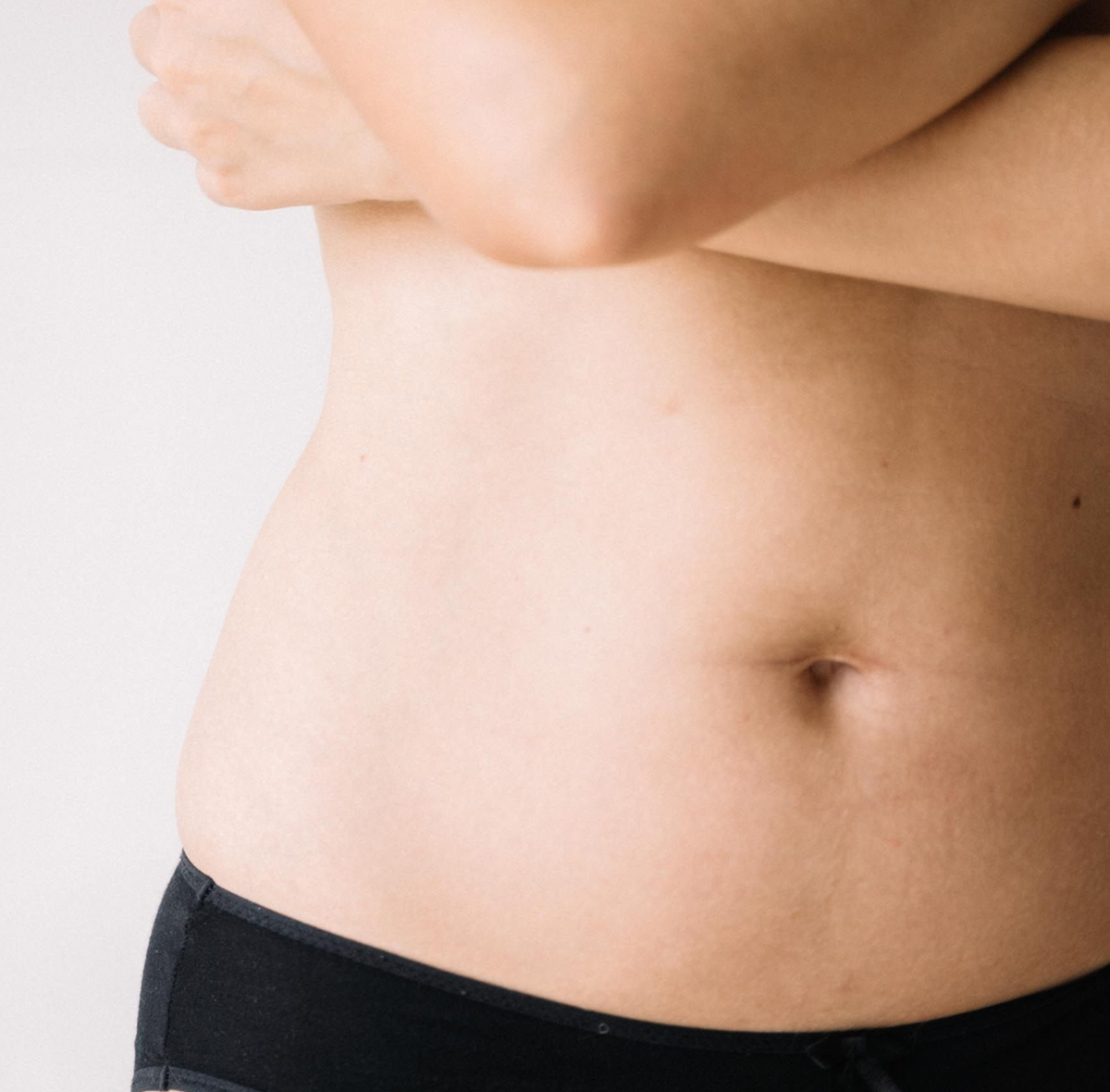 Close-up of a smooth, toned abdomen, representing tummy tuck results in Beverly Hills after weight loss